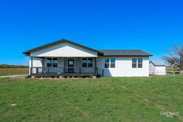 rear view of property with a lawn