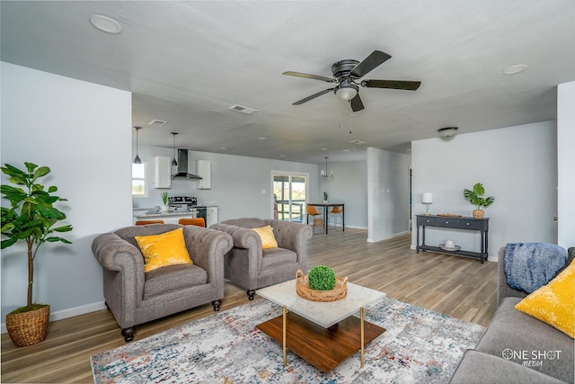 living room with hardwood / wood-style floors, a wealth of natural light, and ceiling fan