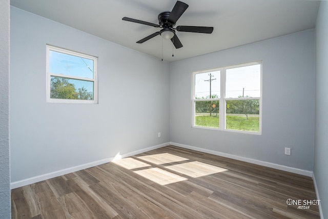 spare room featuring hardwood / wood-style flooring and ceiling fan