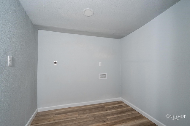 washroom with hardwood / wood-style flooring, hookup for an electric dryer, a textured ceiling, and hookup for a washing machine