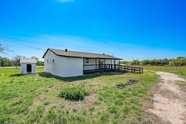 exterior space with a shed and a yard