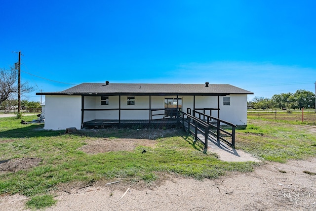 rear view of house with a lawn