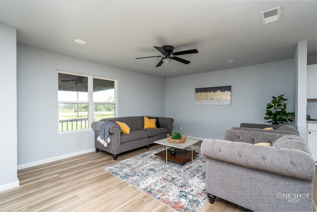 living room with light wood-type flooring and ceiling fan