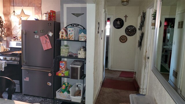 kitchen with gas stove and refrigerator