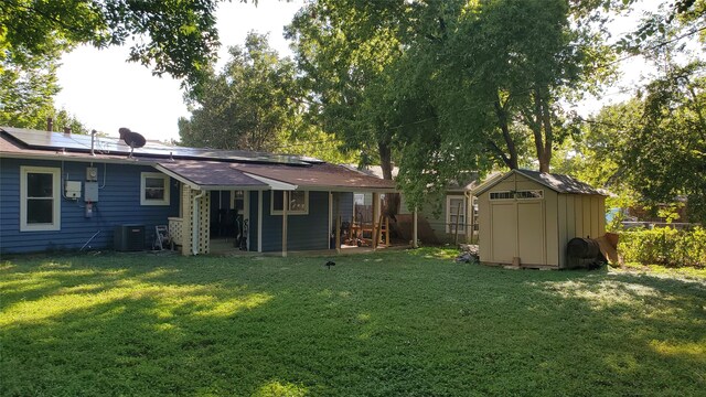 view of yard with central AC and a shed