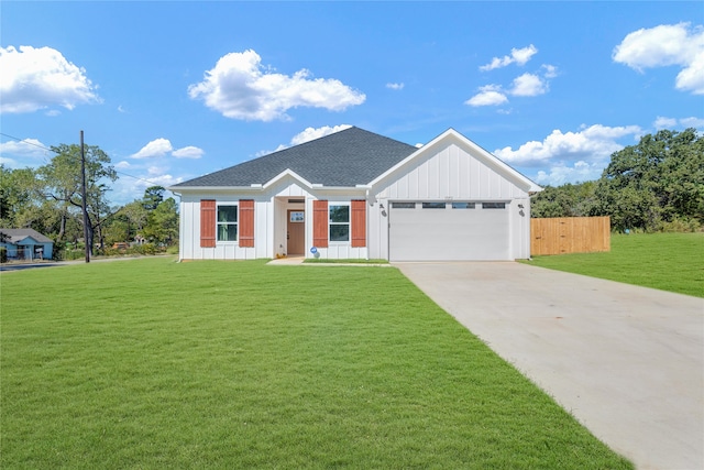 view of front facade featuring a front lawn and a garage