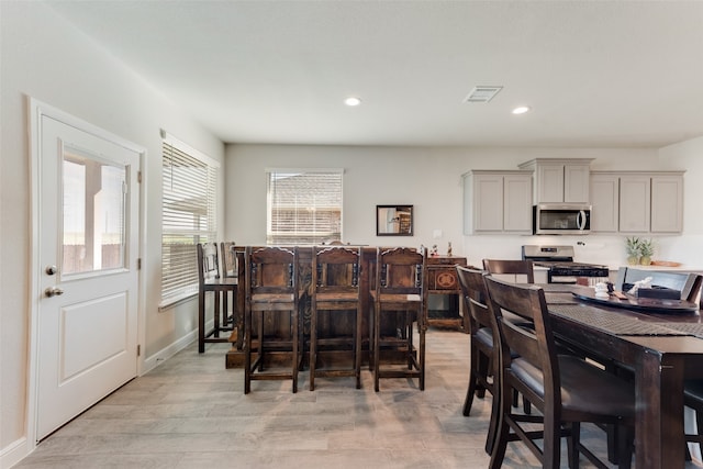 dining space with light hardwood / wood-style flooring