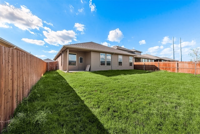 back of house with a lawn