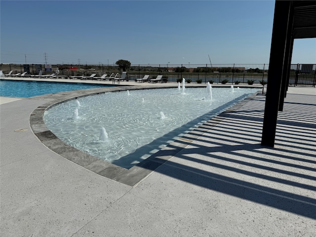 view of swimming pool featuring pool water feature