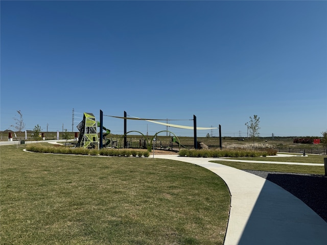 exterior space featuring a playground and a yard