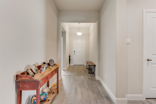 hall with hardwood / wood-style floors