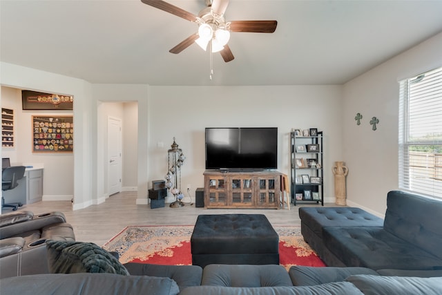 living room with ceiling fan and light hardwood / wood-style flooring