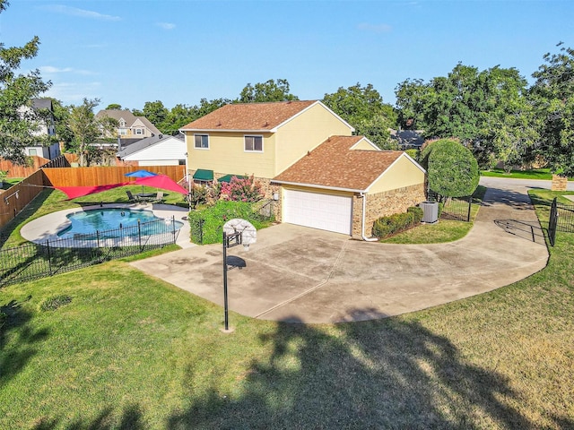 exterior space with a garage, a patio area, a fenced in pool, and a front yard