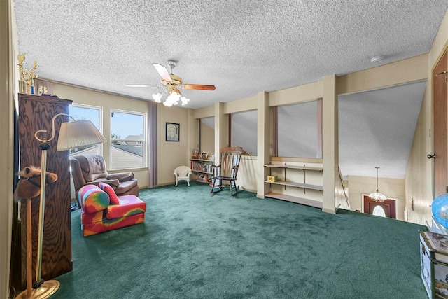 sitting room with a textured ceiling, carpet floors, and ceiling fan