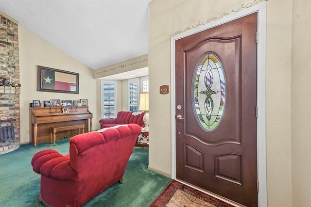 carpeted entryway with a textured ceiling and lofted ceiling