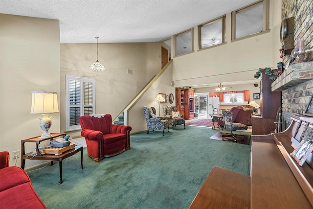 carpeted living room with a fireplace, a textured ceiling, ceiling fan with notable chandelier, and high vaulted ceiling