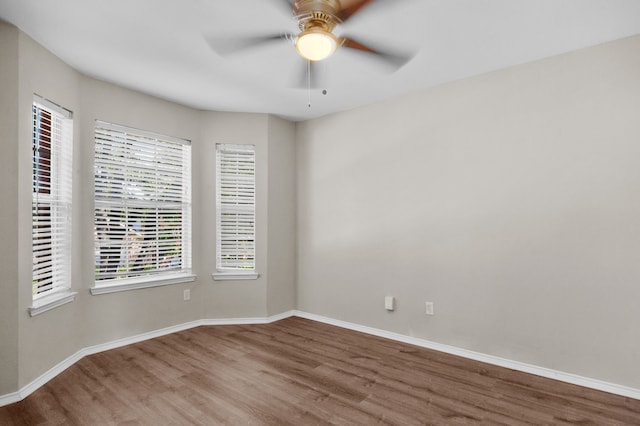 unfurnished room featuring ceiling fan and hardwood / wood-style floors