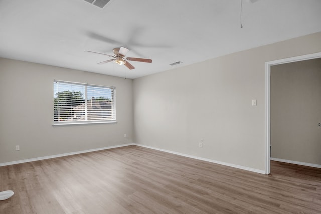 unfurnished room with ceiling fan and light wood-type flooring