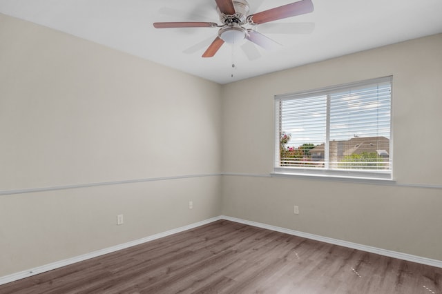 spare room with light wood-type flooring and ceiling fan