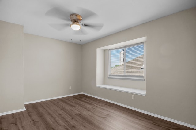 unfurnished room with ceiling fan and dark hardwood / wood-style flooring