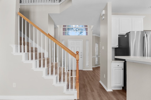 foyer with ornamental molding and hardwood / wood-style flooring