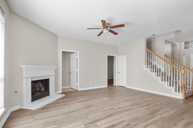 unfurnished living room with ceiling fan and light wood-type flooring