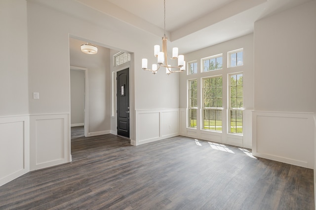 unfurnished dining area with a chandelier, dark wood-type flooring, and a wealth of natural light