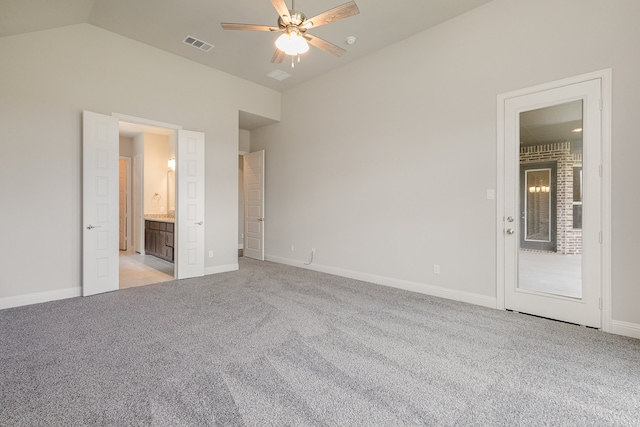 unfurnished bedroom with connected bathroom, vaulted ceiling, ceiling fan, and light colored carpet