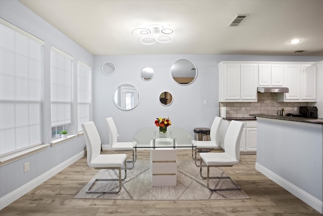 dining space with light hardwood / wood-style flooring