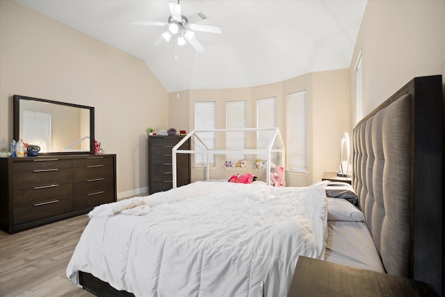 bedroom with ceiling fan, light hardwood / wood-style floors, and lofted ceiling