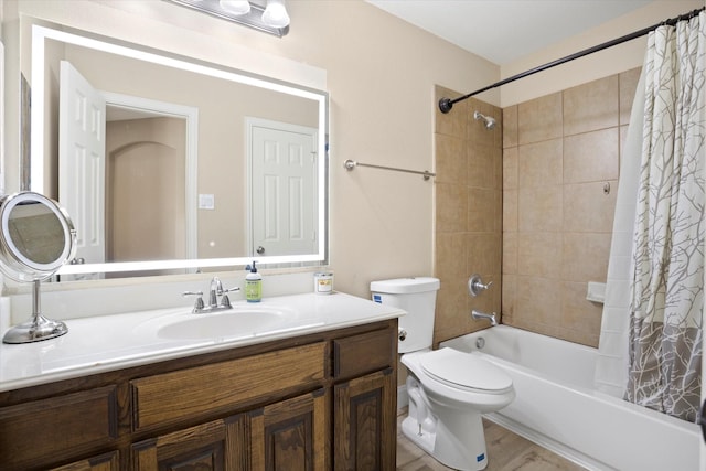 full bathroom with hardwood / wood-style floors, vanity, toilet, and shower / bathtub combination with curtain