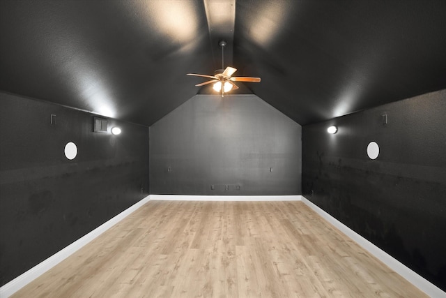 additional living space with ceiling fan, light hardwood / wood-style floors, and vaulted ceiling