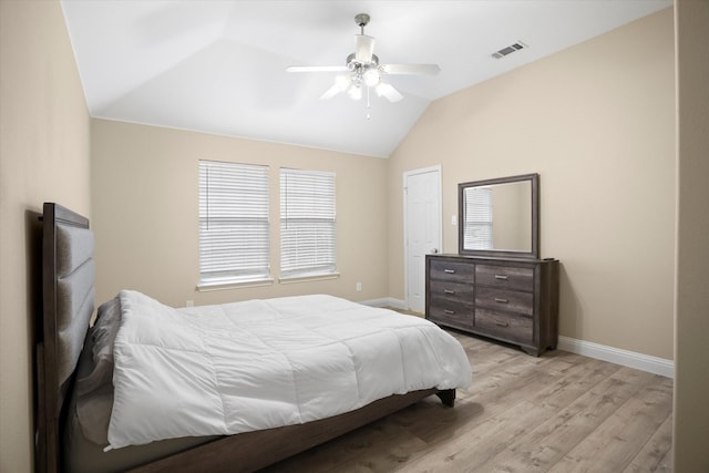 bedroom featuring ceiling fan, lofted ceiling, and light wood-type flooring