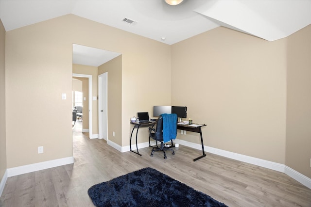 office with light hardwood / wood-style floors and vaulted ceiling