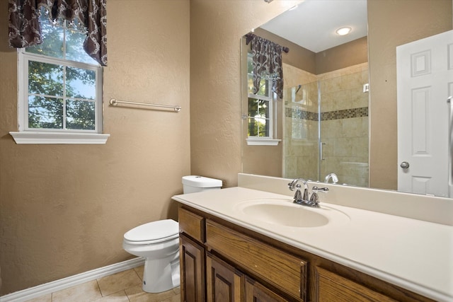 bathroom with tile patterned floors, toilet, a shower with door, and a wealth of natural light