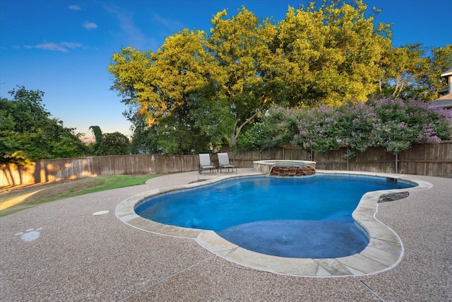 view of pool featuring a patio area and an in ground hot tub