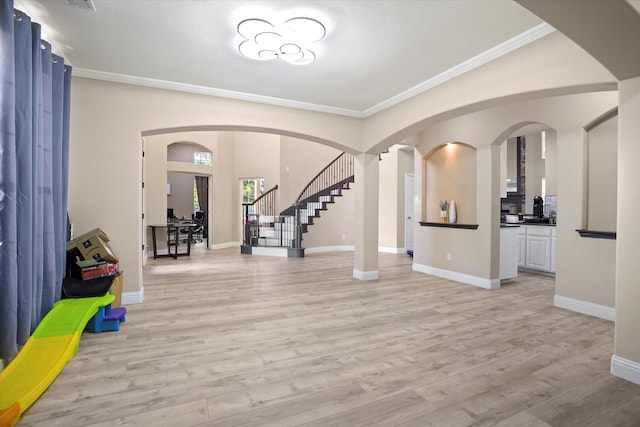 foyer with light hardwood / wood-style floors and ornamental molding