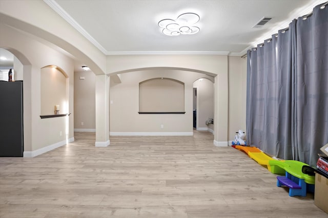 interior space with light wood-type flooring and ornamental molding