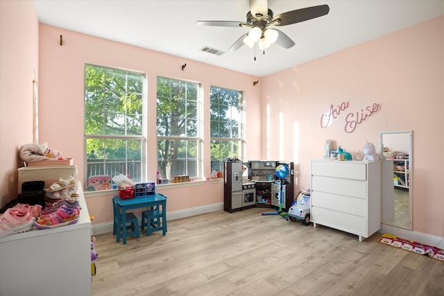 recreation room with light wood-type flooring and ceiling fan