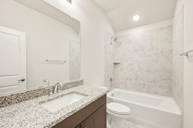 full bathroom featuring vanity, tiled shower / bath combo, toilet, and lofted ceiling