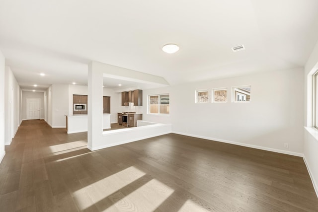 unfurnished living room featuring dark wood-type flooring