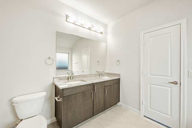 bathroom with toilet, vanity, tile patterned floors, and lofted ceiling