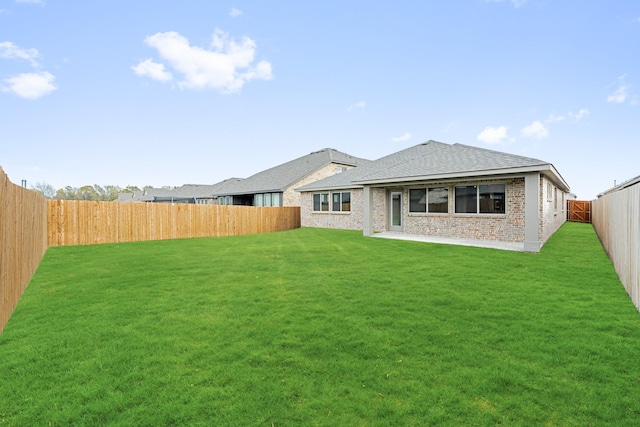 rear view of property featuring a yard