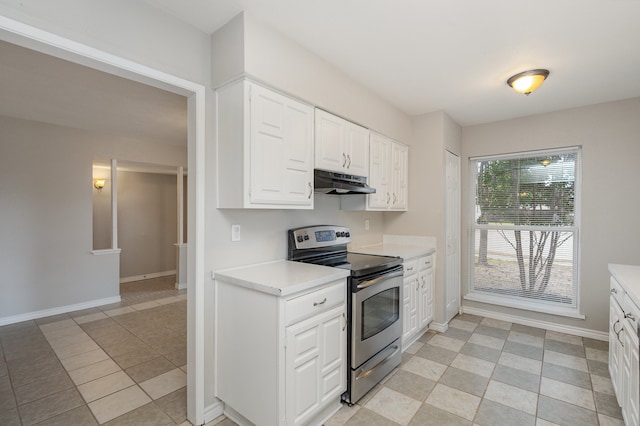 kitchen featuring white cabinets, stainless steel electric stove, and light tile patterned floors