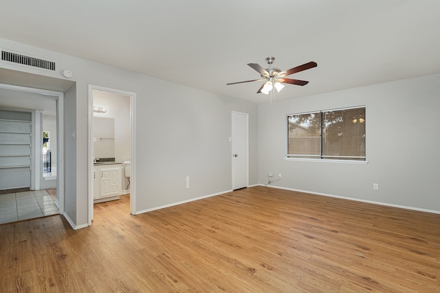 unfurnished bedroom featuring ceiling fan, connected bathroom, and light hardwood / wood-style floors