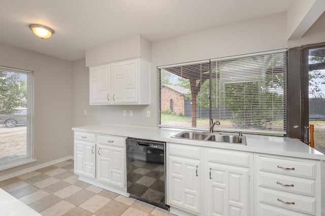 kitchen featuring dishwasher, white cabinetry, a healthy amount of sunlight, and sink