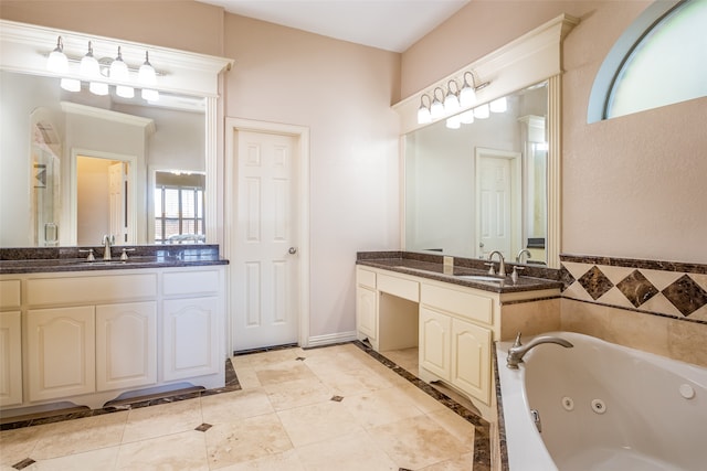 bathroom featuring vanity, tile patterned flooring, a bath, and a wealth of natural light