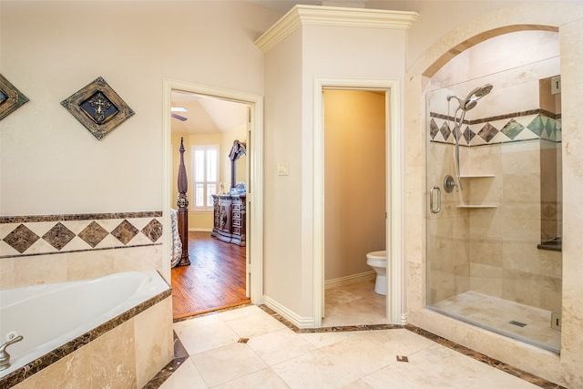 bathroom with toilet, plus walk in shower, and hardwood / wood-style flooring