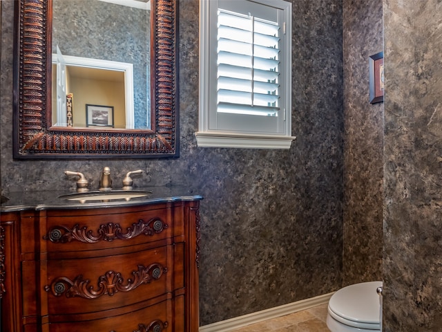 bathroom with vanity, toilet, and tile patterned floors