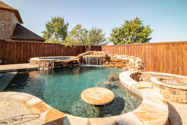 view of swimming pool with an in ground hot tub and pool water feature